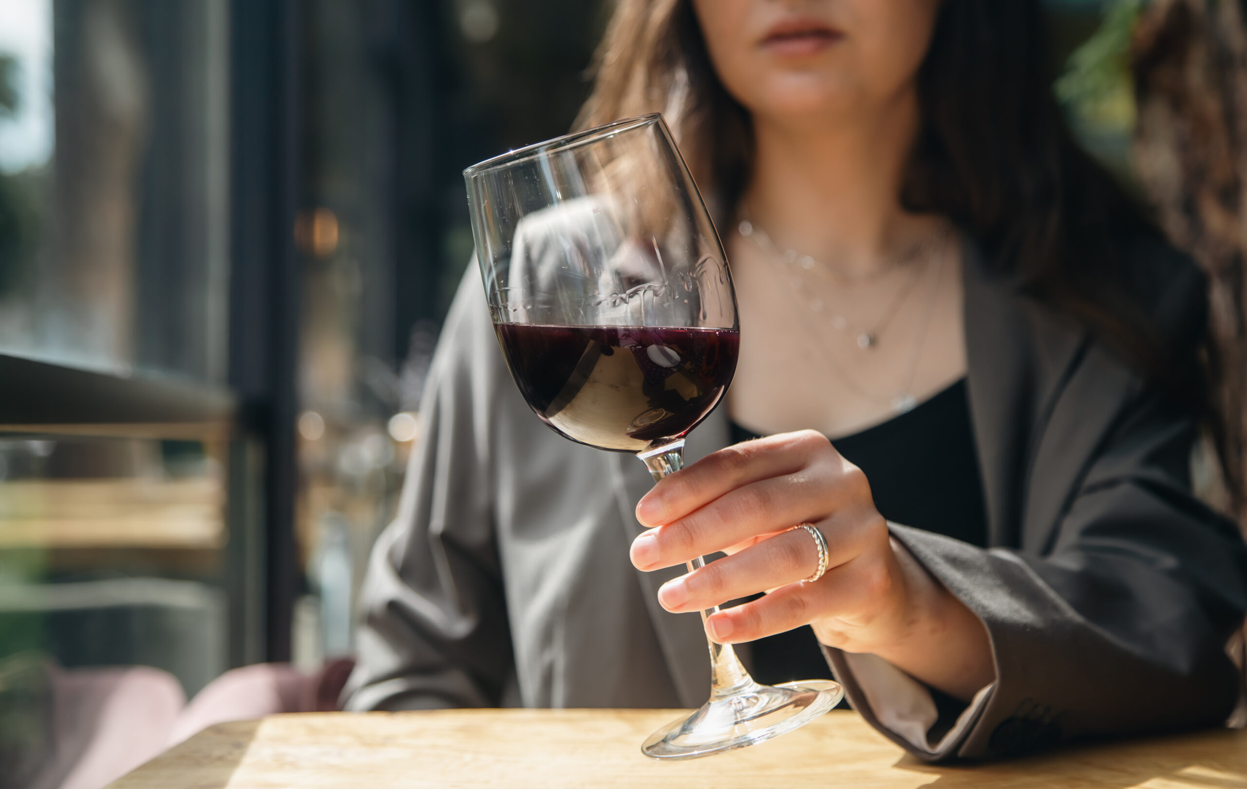 Close-up image of a woman holding a wine glass