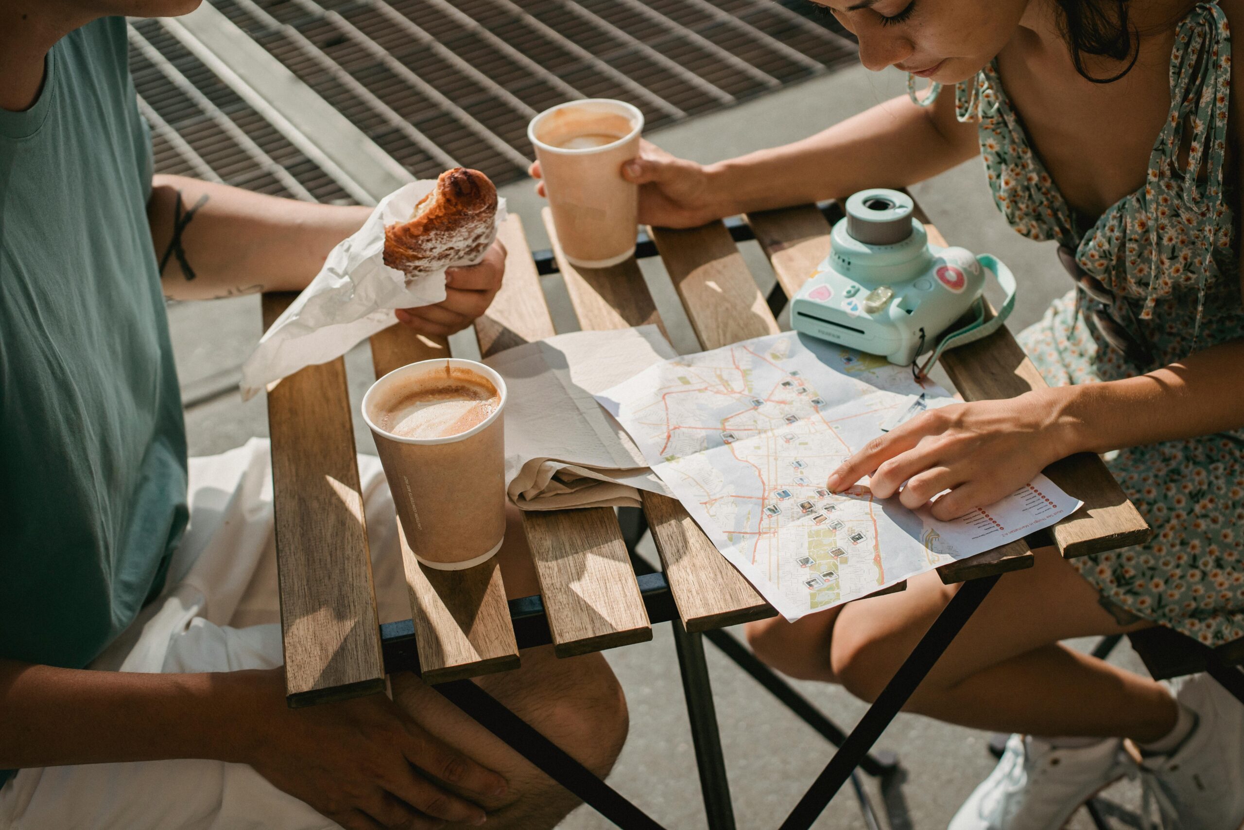 Two people eating while looking at a wine tour map