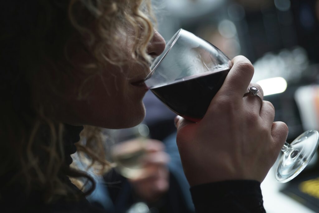 A woman drinking a glass of wine