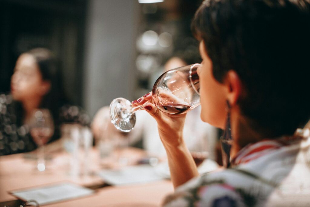 A woman attending wine tasting event