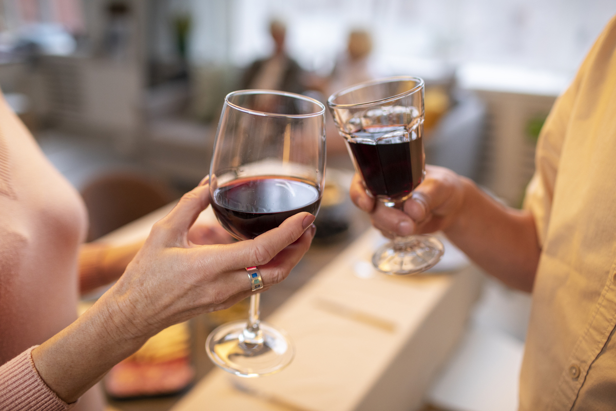 Two people toasting with wine glasses