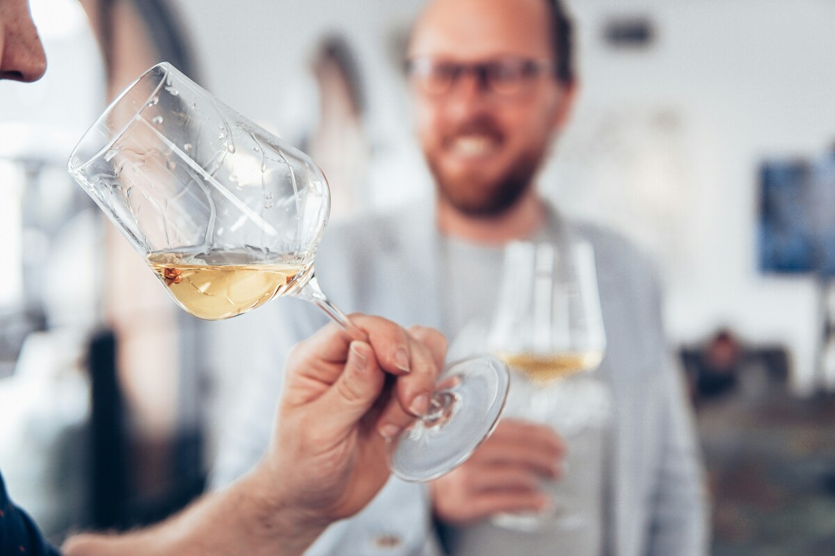 A person smelling a glass of wine