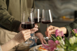 Three individuals sampling wine at a tasting event